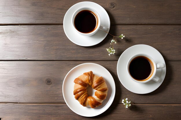 surface en bois avec des brindilles décoratives Café avec croissant et fleurs