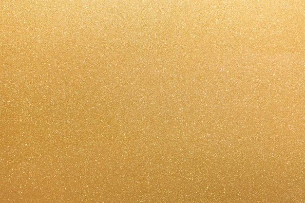 Surface jaune orange paillettes dorées avec des taches irrégulières blanches clignotantes, fond de l'espace de copie.