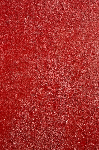 Photo surface en métal rouillé peint en rouge rugueux, texture haute résolution.