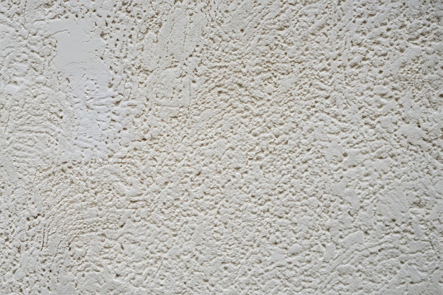 Surface et texture abstraites d'un mur de pierre en béton blanc