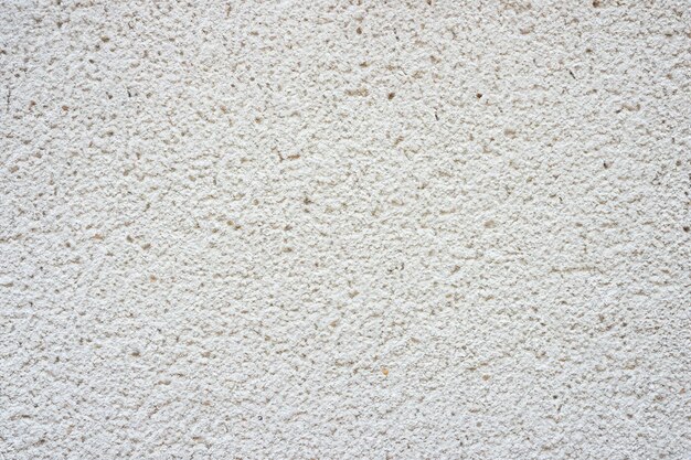 Photo surface et texture abstraites d'un mur de pierre en béton blanc