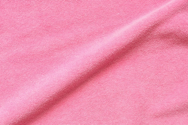 Surface de texture de tissu serviette rose bouchent fond