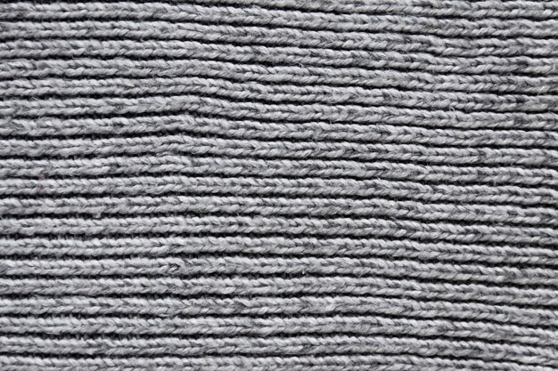 Surface tricotée en laine de textile gris se bouchent. Fond textile naturel. Modèle de tricot lourd.