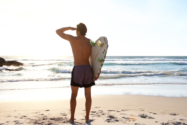 Surfer en regardant les vagues dans la mer