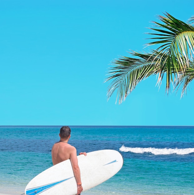 Surfeur avec planche de surf près de l'estran