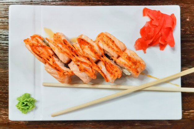 Sushi japonais et rouleaux sur une table en bois japonaise avec sauce wasabi