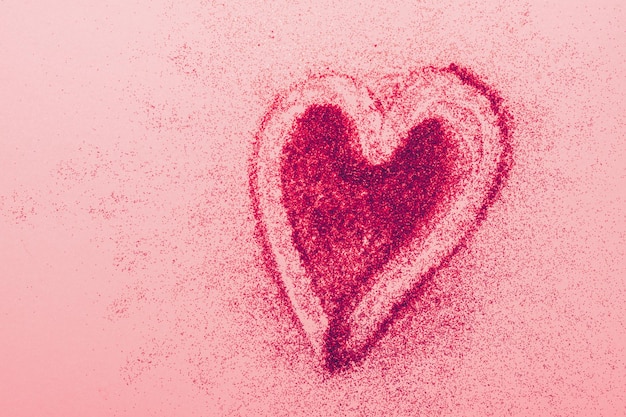 Symbole de coeur rouge de l'amour de fond rose scintille concept de cosmétiques Saint Valentin espace de copie de cadre horizontal