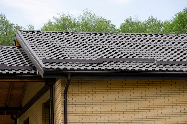 Système de gouttière en plastique sur une maison en briques