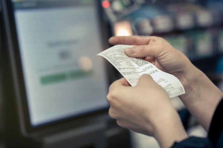 Photo système de point de vente pour le reçu des produits au détail entre les mains des femmes dans le magasin imprimante de reçus du processeur de carte de crédit avec facture papier et écran tactile