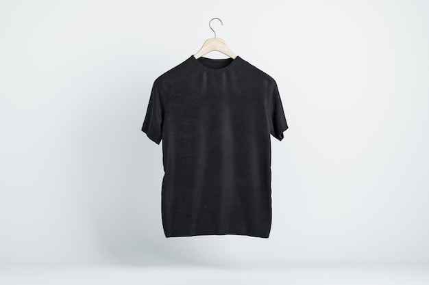 T-shirt ajusté moderne noir vierge sur cintre en bois avec espace pour votre logo sur fond d'écran clair maquette de rendu 3D