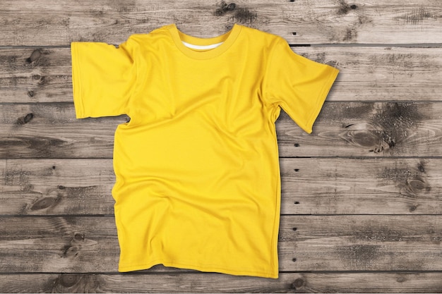 Photo t-shirt jaune blanc sur fond de bois