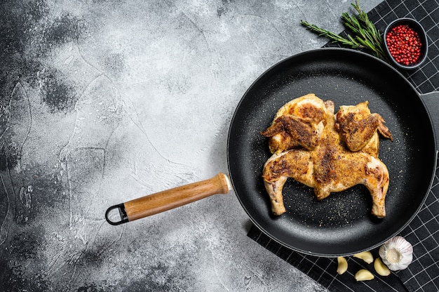 Tabaka de poulet rôti frit grillé dans une casserole. Vue de dessus