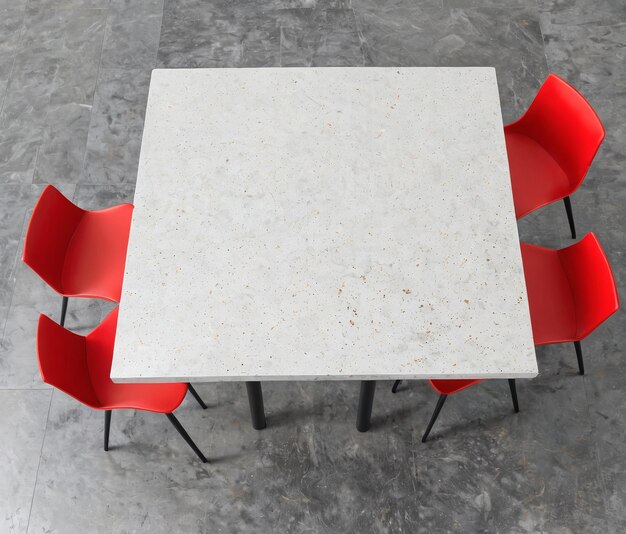 une table blanche avec des chaises rouges