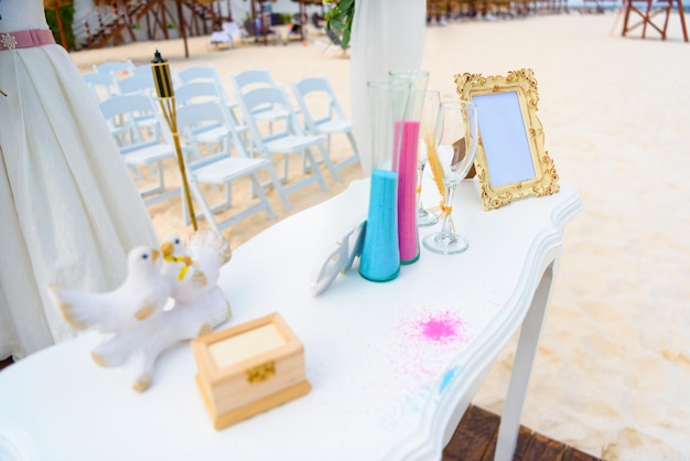 Table blanche pour une cérémonie de mariage avec des décorations au bord de la mer