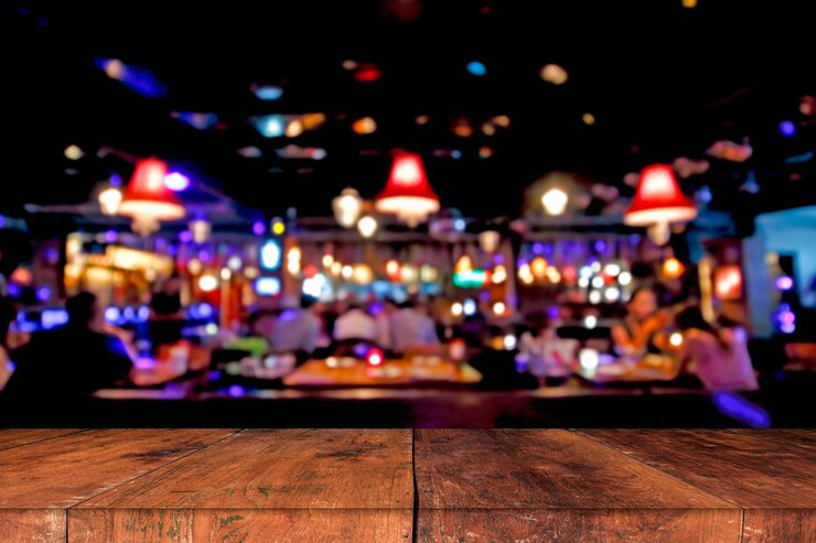 Photo table en bois devant un arrière-plan flou abstrait de lumières de restaurant
