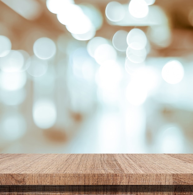 Table en bois vide sur fond clair flou bokeh abstrait