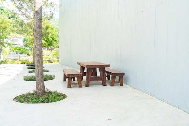 table et chaise de patio extérieur en bois vide avec mur blanc
