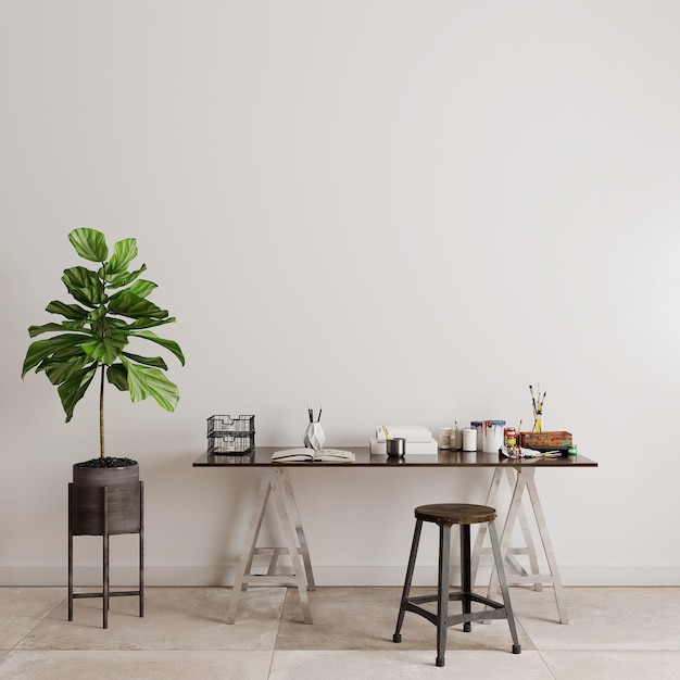 Table et chaises avec des plantes vertes devant le mur blanc