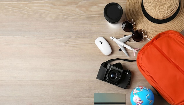 Une table avec un chapeau, un appareil photo, un appareil photo, un passeport et un chapeau dessus.