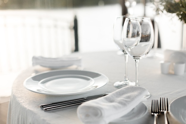 Photo table dressée au restaurant à la lumière pour un mariage, un dîner romantique ou une célébration