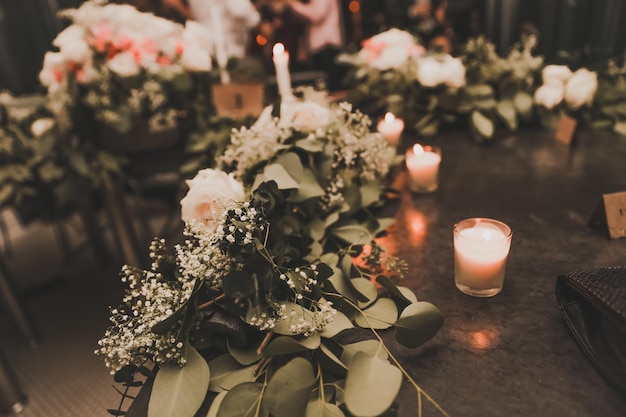 Une table avec des fleurs et des bougies dessus