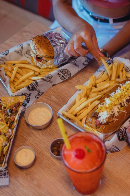 Photo table avec jus de hot dog hamburgers et nachos