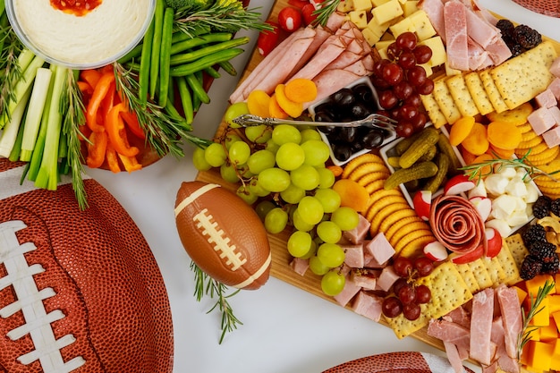 Table pleine de délicieuses collations pour une partie de football pour les fans.