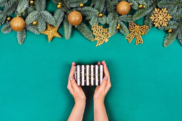 Table verte de Noël avec les mains et les cadeaux.