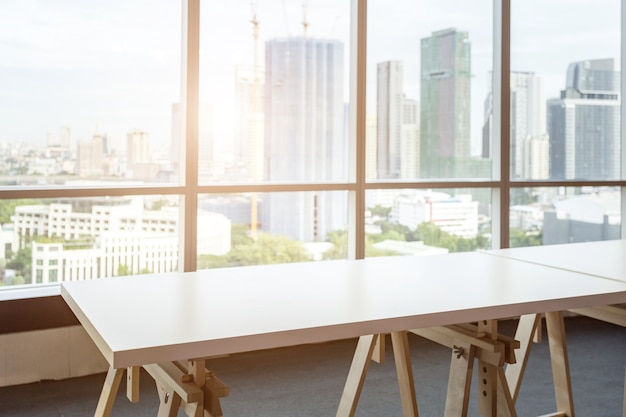 Table vide dans le bureau de la salle et la fenêtre arrière-plan de la ville.