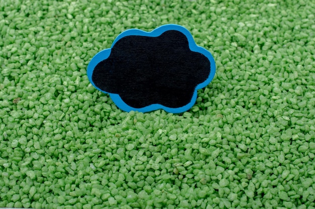 Tableau d'affichage avec cadre sur du sable de couleur verte