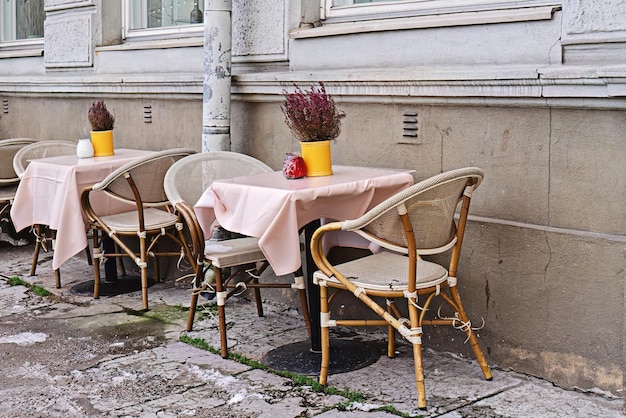 Tables de café vides sur la rue de la ville attendant les visiteurs Blues d'automne Fleurs d'automne Heather