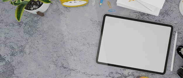 tablette écran vide stylet horloge plantes trucs et espace de copie sur table loft en couleur grise