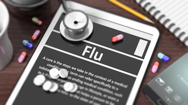 Tablette avec grippe sur écran stéthoscope pilules et objets sur bureau en bois