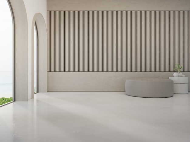 Tabouret rond sur sol en béton blanc d'un salon lumineux dans une maison de plage moderne ou un hôtel de luxe