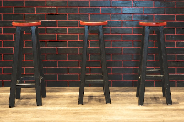 Tabourets de bar noirs avec un siège rouge.