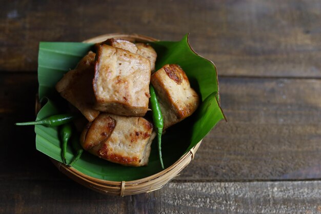 Tahu bacem est une cuisine traditionnelle de Java Indonésie servie sur une assiette en bois avec une feuille de bananier