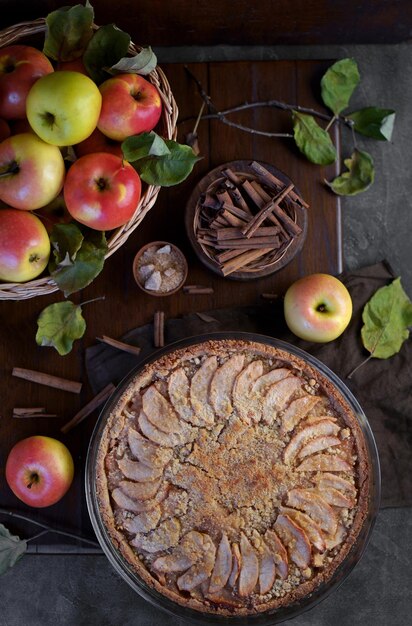 Tarte aux pommes avec des fruits frais sur une table en bois