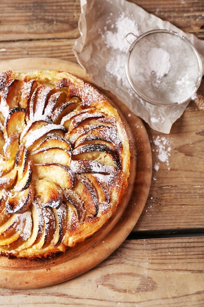 Tarte aux pommes maison sur planche à découper sur bois