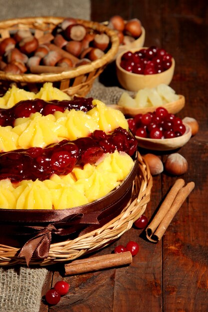 Tarte maison fruitée savoureuse avec des baies et des écrous, sur la table en bois brune