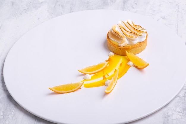 Tartelettes appétissantes au citron avec meringue servies sur une assiette blanche