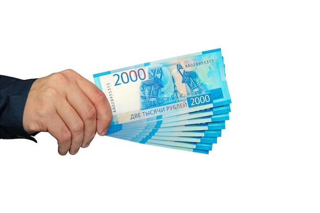 Tas de billets de banque russes roubles dans la main de l'homme
