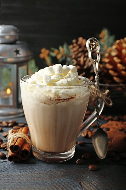 Tasse de cacao chaud avec guimauve, biscuits et lanterne sur tableau noir