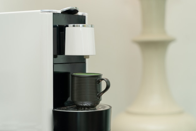 Tasse de café en céramique sur la machine à café. Machine à café à capsules.