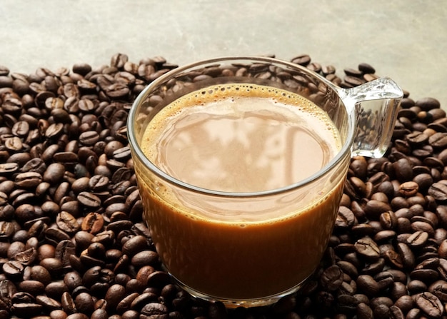 Une tasse de café chaud sur fond de grains de café