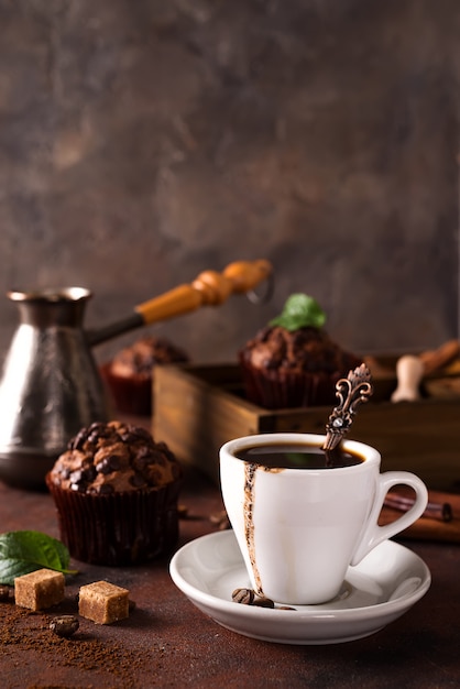 Tasse de café chaud à la vapeur avec grains de café, moulin à café et sac de grains de café