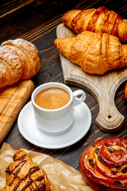 Tasse de café et croissant sur fond en bois