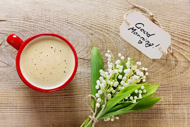 Photo tasse à café avec fleurs et notes sur un fond rustique en bois