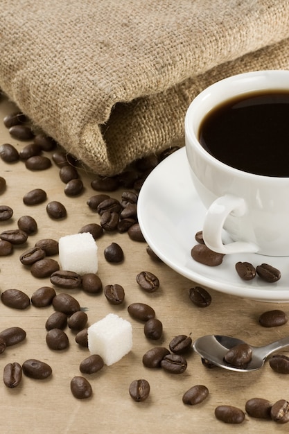 Tasse de café et de grains au sac sur sépia