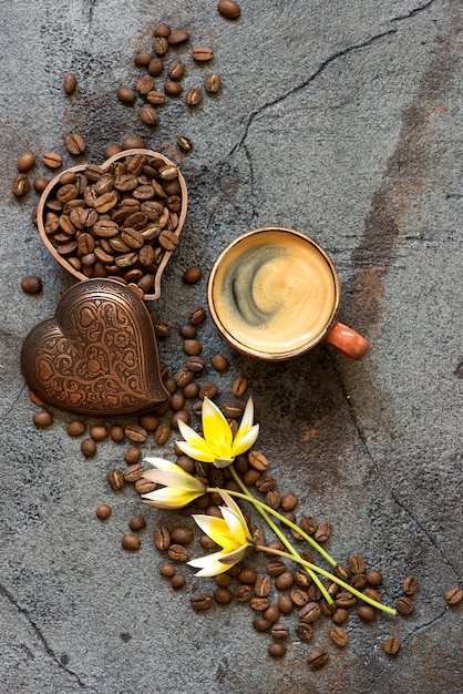 Tasse à café et grains de café sur fond gris