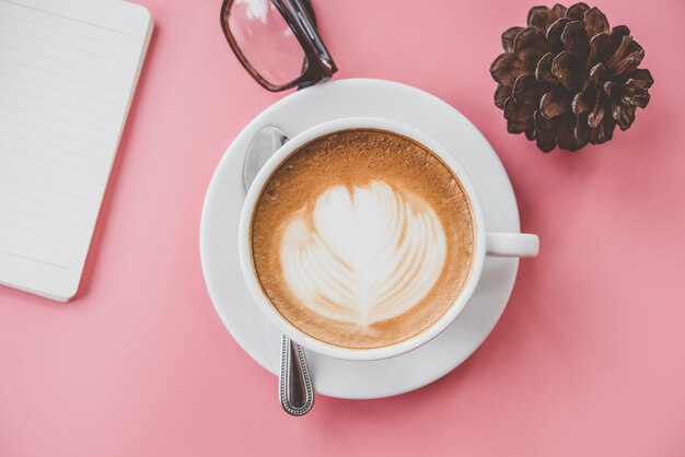 Tasse De Café Latte Art Forme De Coeur Avec Des Outils De Bureau Sur La Table Rose